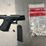 Glock handgun with heroin inside clear evidence bag on metal surface
