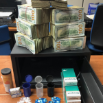 Photo of money, drugs, and cigarettes resulted from search warrant