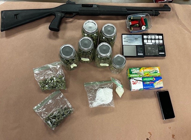 Photo of drug, paraphernalia, and firearm collected from search warrant