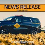 Graphic titled “News Release Kent County” featuring a Delaware State Police Chevrolet Tahoe parked in a crop field with farming equipment in the background. A silhouette map of Delaware appears on the left with Kent County highlighted in blue, the text “BecomeATrooper.com” on the bottom center, and social media icons are shown at the bottom right corner.