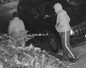 Black and white surveillance screen capture of the suspects
